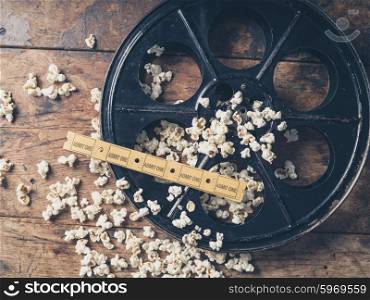 Cinema concept of vintage film reel with popcorn and movie tickets