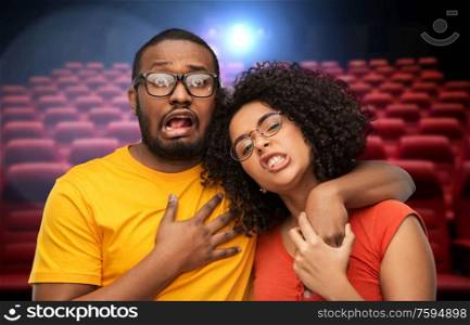 cinema, entertainment and people concept - african american couple over movie theatre background. african american couple over movie theatre