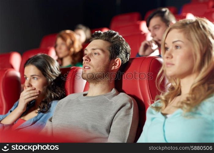 cinema, entertainment and people concept - happy friends watching horror, drama or thriller movie in theater