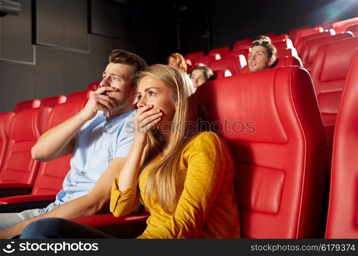 cinema, entertainment and people concept - happy friends watching horror, drama or thriller movie in theater