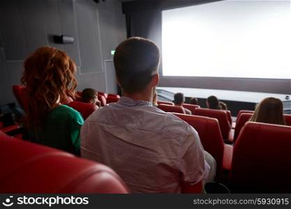 cinema, entertainment, leisure and people concept - couple watching movie in theater from back