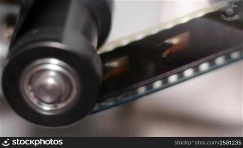 Cinema projector film gear detail. 35mm film projection cinema technical footage. Film Technician mounting a 35mm film reel in a film festival.