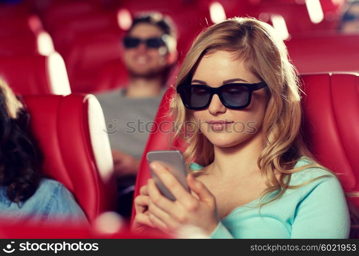 cinema, technology, entertainment and people concept - happy woman with 3d glasses and smartphone reading message in movie theater