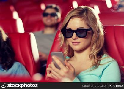 cinema, technology, entertainment and people concept - happy woman with 3d glasses and smartphone reading message in movie theater