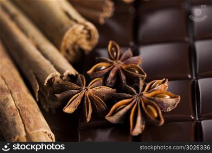 Cinnamon and anise, Dark chocolate with candy sweet. Bars Chocolate , candy sweet, dessert food on wooden background