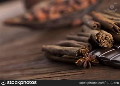 Cinnamon and anise, Dark chocolate with candy sweet. Bars Chocolate , candy sweet, dessert food on wooden background