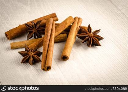 Cinnamon and anise on the wooden background