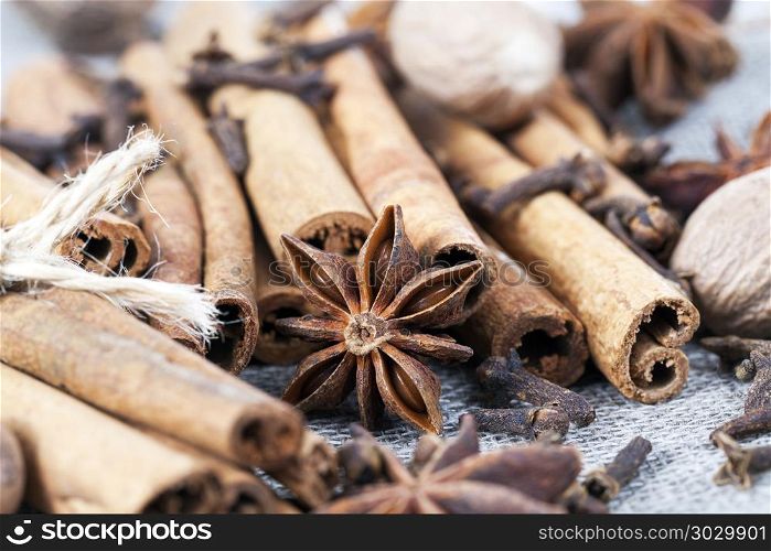 cinnamon and anise with nutmeg. chaotic pleasant smell from whole cinnamon sticks and anise with nutmeg while preparing oriental dishes in the kitchen, close-up, a shallow depth of field
