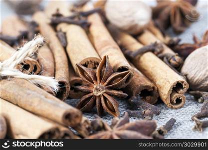 cinnamon and anise with nutmeg. chaotic pleasant smell from whole cinnamon sticks and anise with nutmeg while preparing oriental dishes in the kitchen, close-up, a shallow depth of field