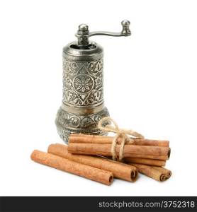 cinnamon and manual coffee grinder isolated on white background