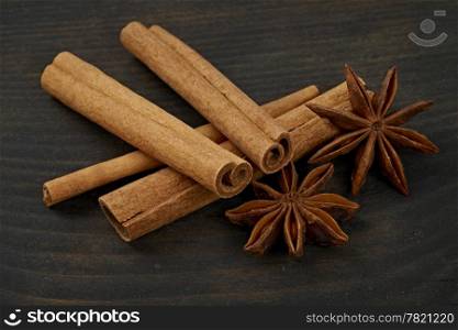 Cinnamon and star anise in an old wooden board. Close-up.