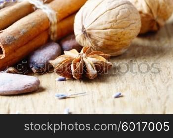 Cinnamon, cocoa, and anise on wooden table