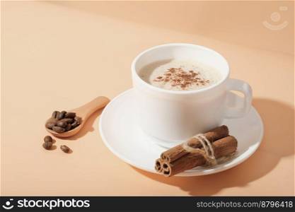 cinnamon coffee cappuccino in white classic cup on beige background. hot autumn and winter spicy coffee. seasonal hot drinks.. cinnamon coffee cappuccino in white classic cup on beige background. hot autumn and winter spicy coffee. seasonal hot drinks