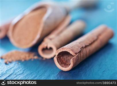 cinnamon in wooden spoon and on a table
