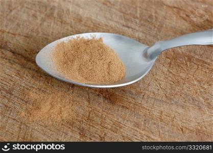 Cinnamon on a spoon on a bg