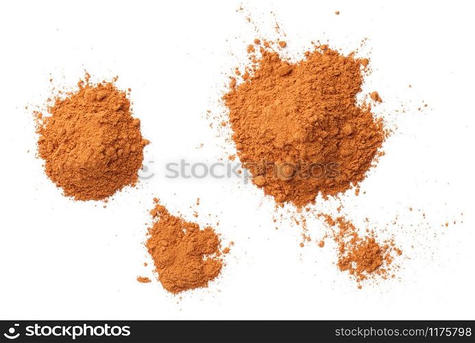 Cinnamon powder piles isolated on white background, with shadow. Flat lay. Top view