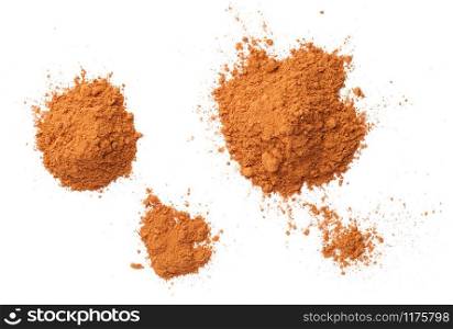 Cinnamon powder piles isolated on white background, with shadow. Flat lay. Top view