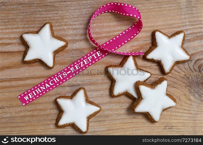 Cinnamon star on wood with Weihnachts - Rezepte (in german Christmas Recipes) gift ribbon.. Cinnamon star on wood with Weihnachts - Rezepte (in german Christmas Recipes) gift ribbon