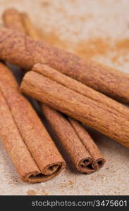 Cinnamon stick closeup on a brown background