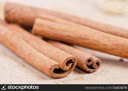 Cinnamon stick closeup on a brown background