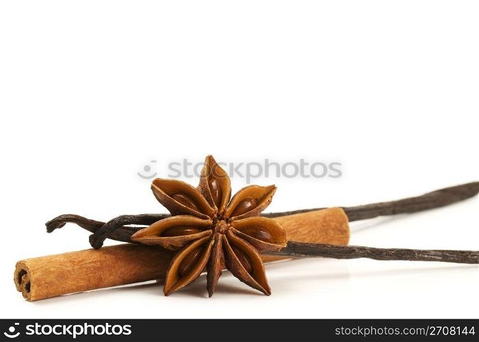cinnamon stick star anise and two vanilla beans. cinnamon stick, star anise and two vanilla beans on white background