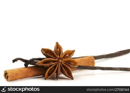 cinnamon stick star anise and two vanilla beans. cinnamon stick, star anise and two vanilla beans on white background