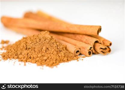 Cinnamon sticks and cinnamon powder herbs and spices on white background