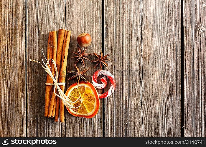 Cinnamon sticks and other spices over wooden table