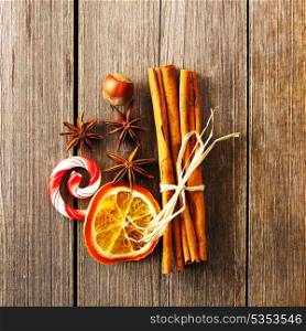 Cinnamon sticks and other spices over wooden table