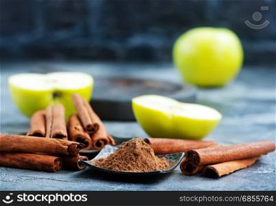 cinnamon sticks and powder on a table