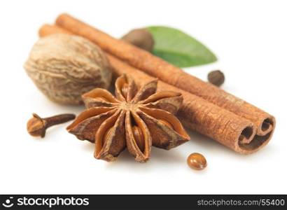 cinnamon sticks, anise star and other spices on white background