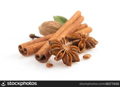 cinnamon sticks, anise star and spices on white background