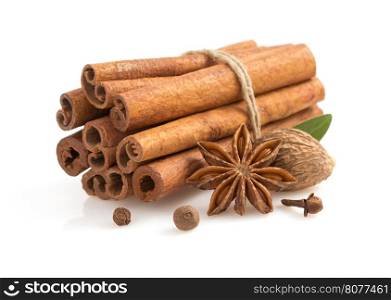cinnamon sticks, anise star and spices on white background