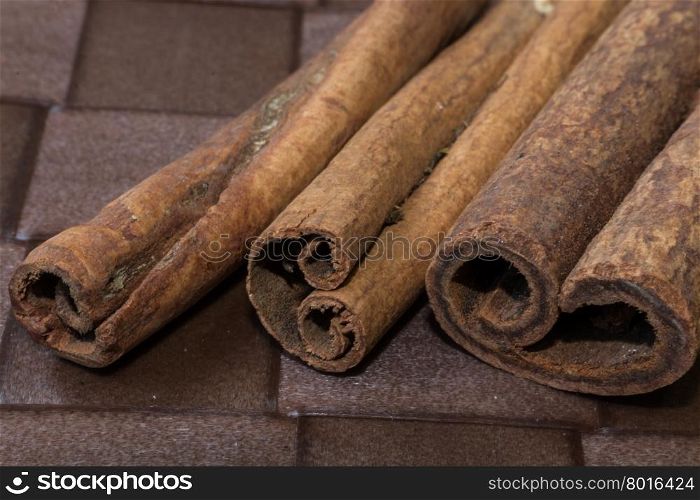 Cinnamon sticks close-up on brown background