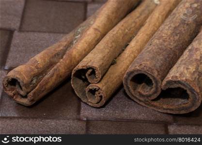 Cinnamon sticks close-up on brown background