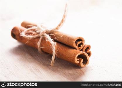 Cinnamon sticks close up on wooden table