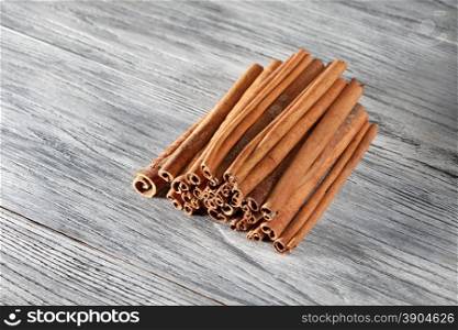 Cinnamon sticks isolated on white wooden background. Cinnamon sticks isolated on white wooden table
