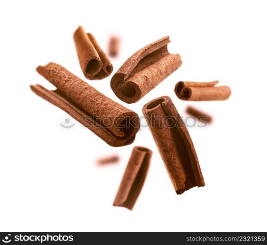 Cinnamon sticks levitate on a white background.. Cinnamon sticks levitate on a white background