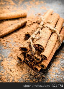 Cinnamon sticks. On a black wooden table.. Cinnamon spice sticks.