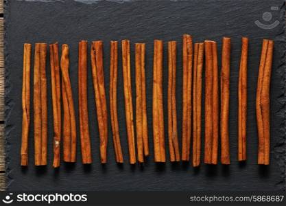 Cinnamon sticks on slate background