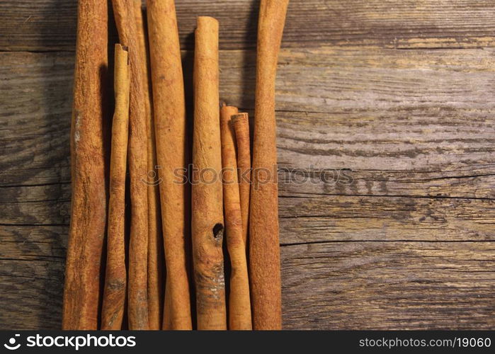 cinnamon sticks on wooden background