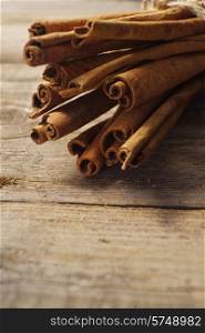 cinnamon sticks on wooden background