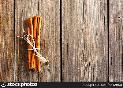 Cinnamon sticks over wooden table