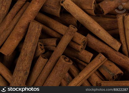 Cinnamon sticks spice closeup background. Texture of cinnamon sticks. Top view image