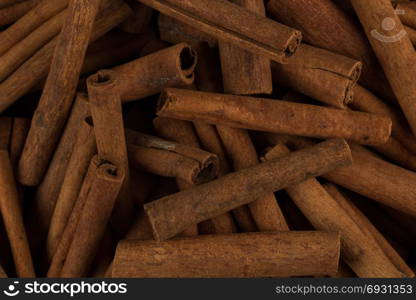 Cinnamon sticks spice closeup background. Texture of cinnamon sticks. Top view image