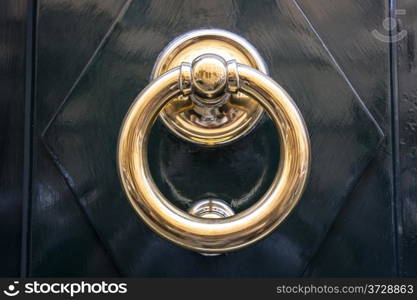 circle iron door-handle on black door