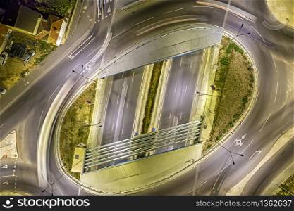 Circle junction traffic road with car light movement aerial view from a drone.