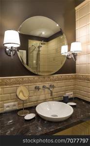 Circle mirror in a luxurious bathroom