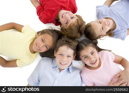 Circle of five young friends smiling