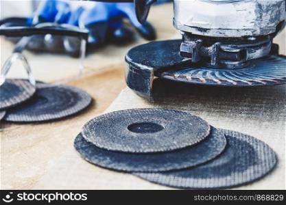 circles for the angle grinder are on wooden boards near the grinder. The concept of tools and repair work.. circles for the angle grinder are on wooden boards near the grinder.